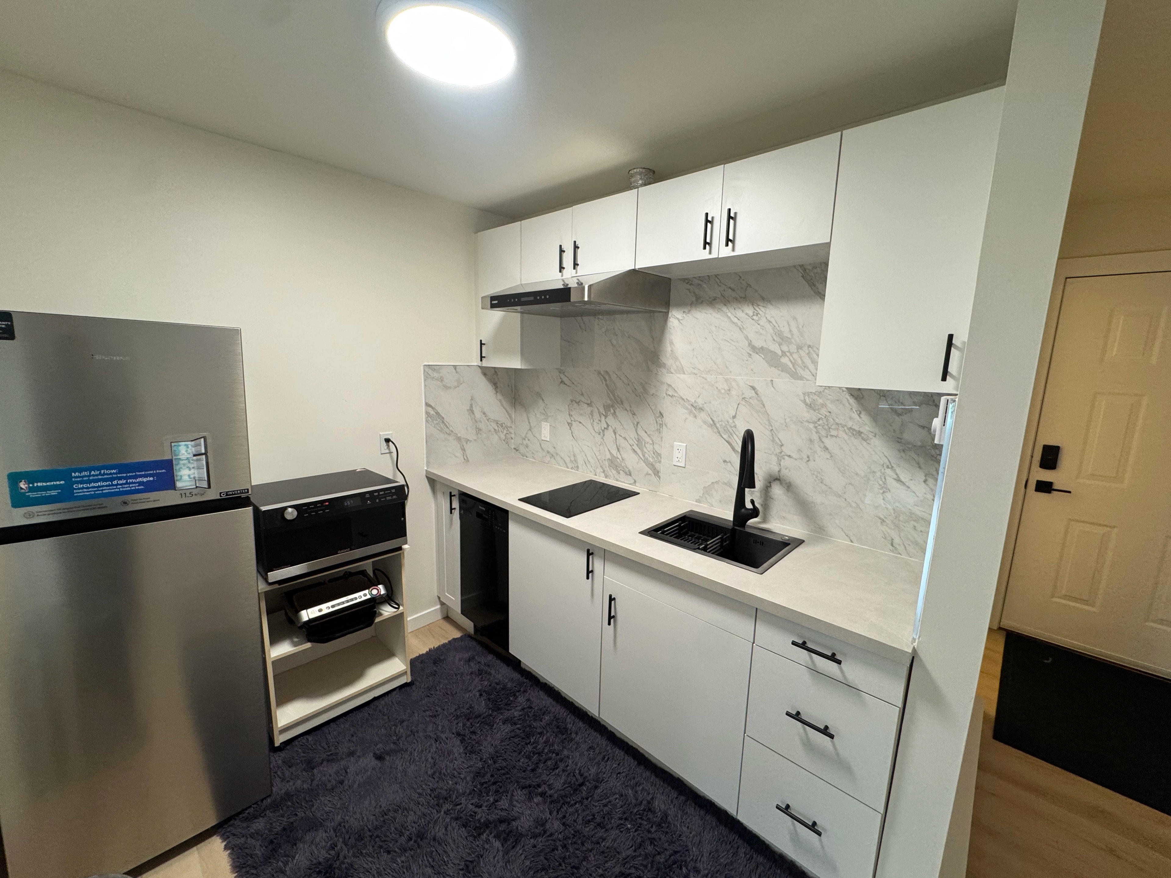 condo kitchen and marble baths by CVR Construction