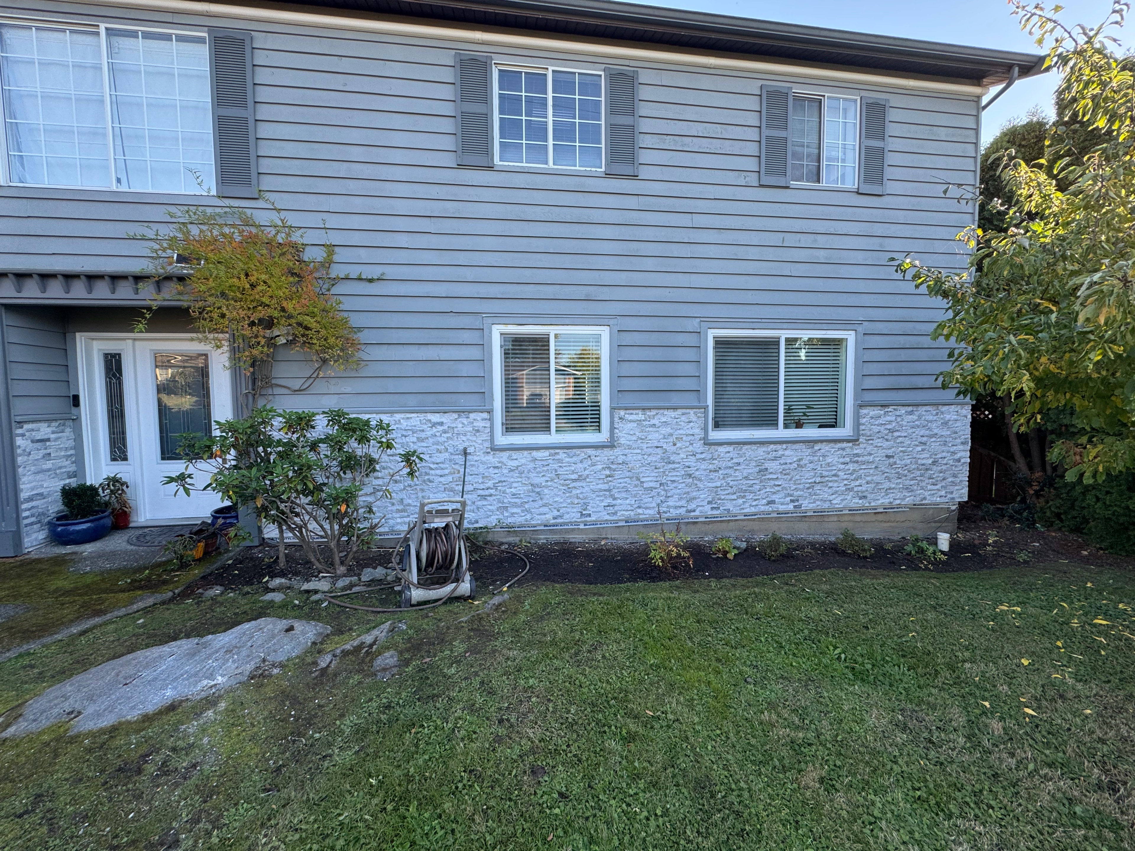gray siding and forest shed by CVR Construction