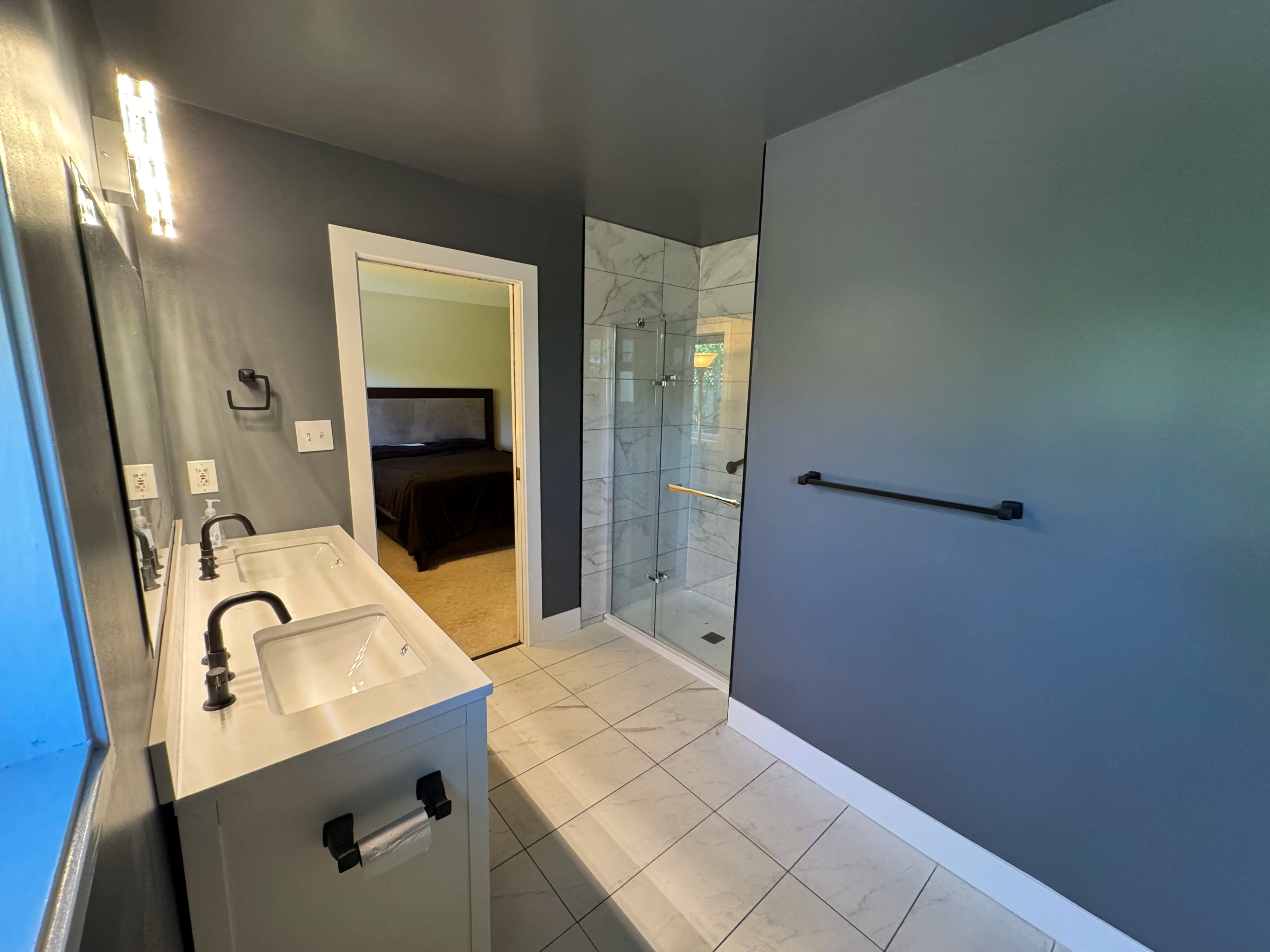 Modern bathroom and laundry suite remodel by CVR Construction